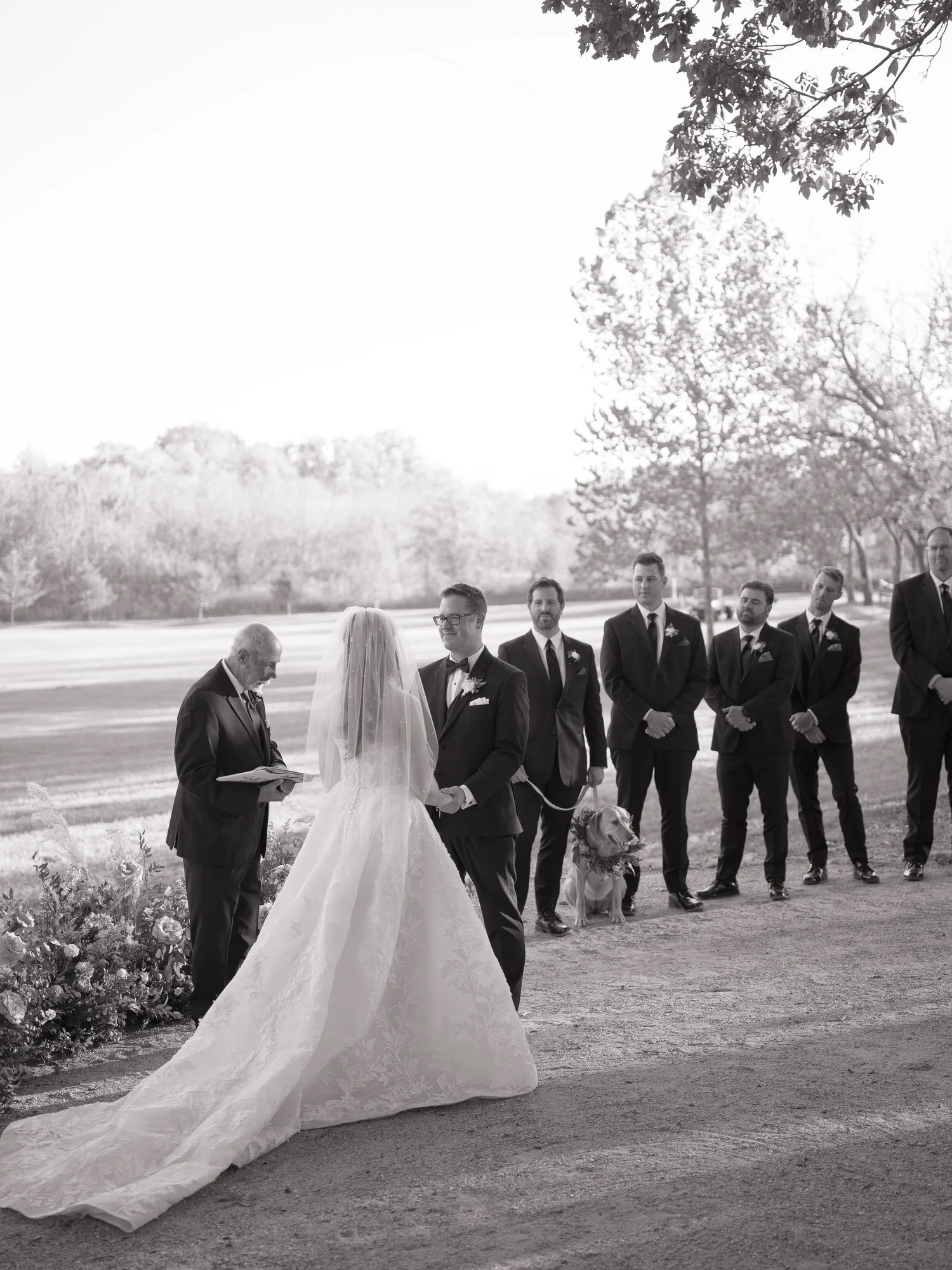 Lauren and Adam exchanging vows outdoors at The Barn at Riverbend