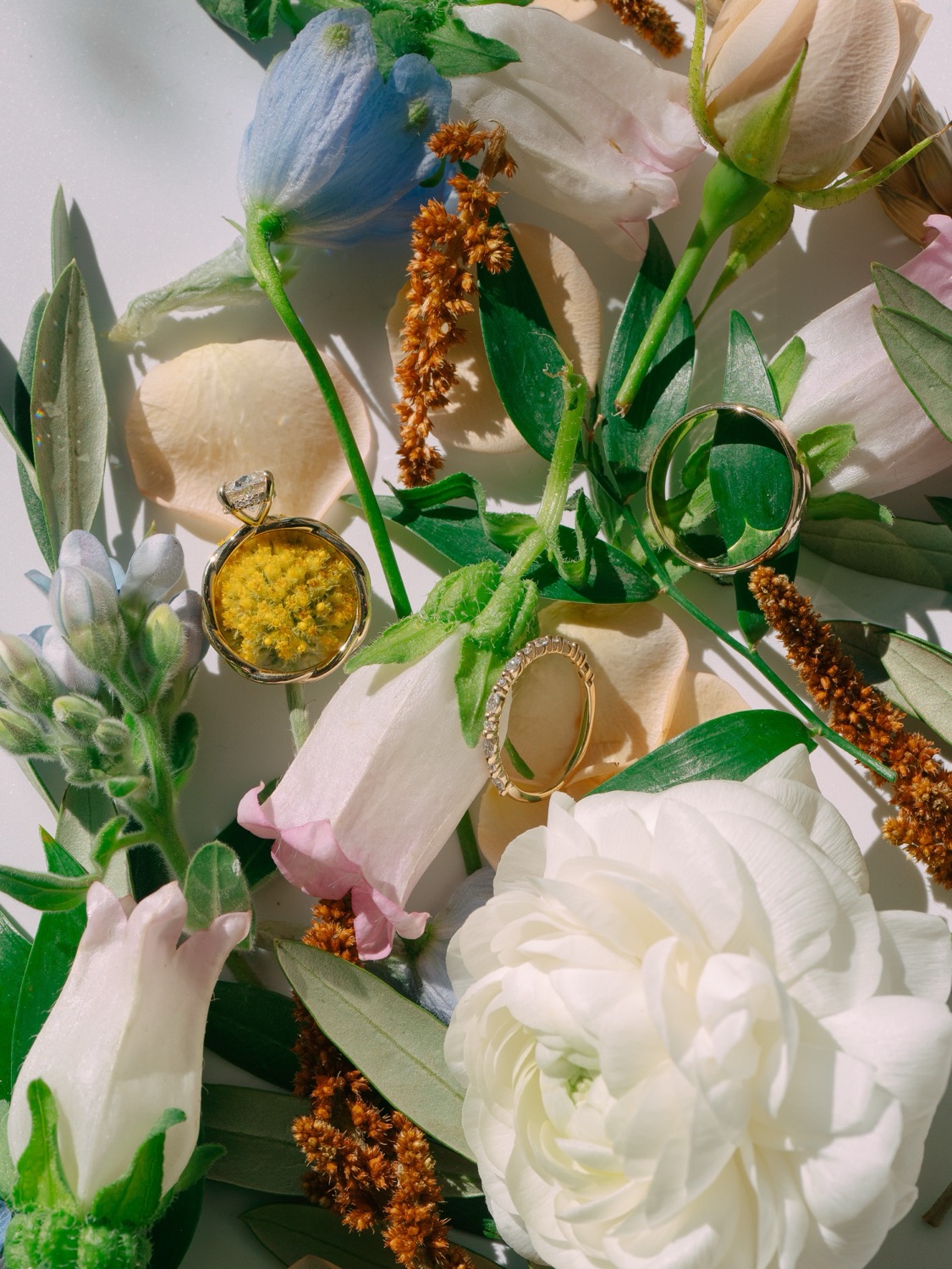 Lauren and Adam's wedding rings arranged with flowers